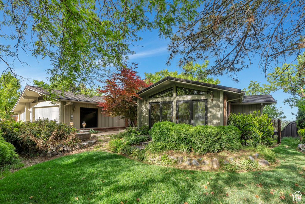 Back of property featuring a lawn