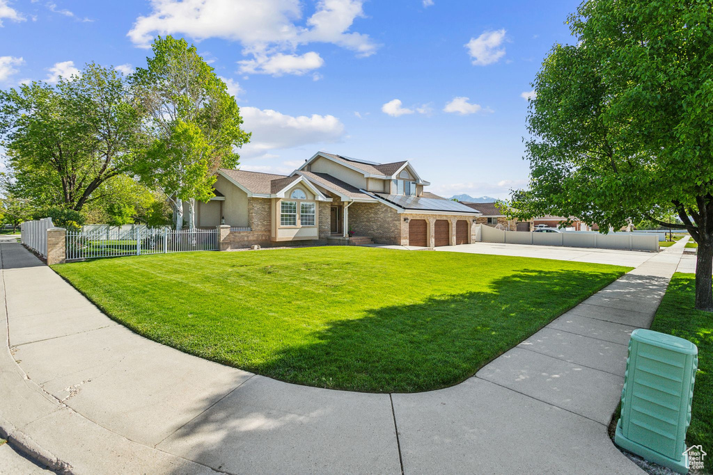 View of front facade featuring concrete driveway, a garage, stone siding, and brick siding