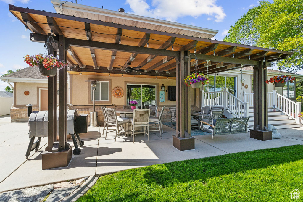 View of patio / terrace featuring ceiling fan, grilling area, and outdoor dining space