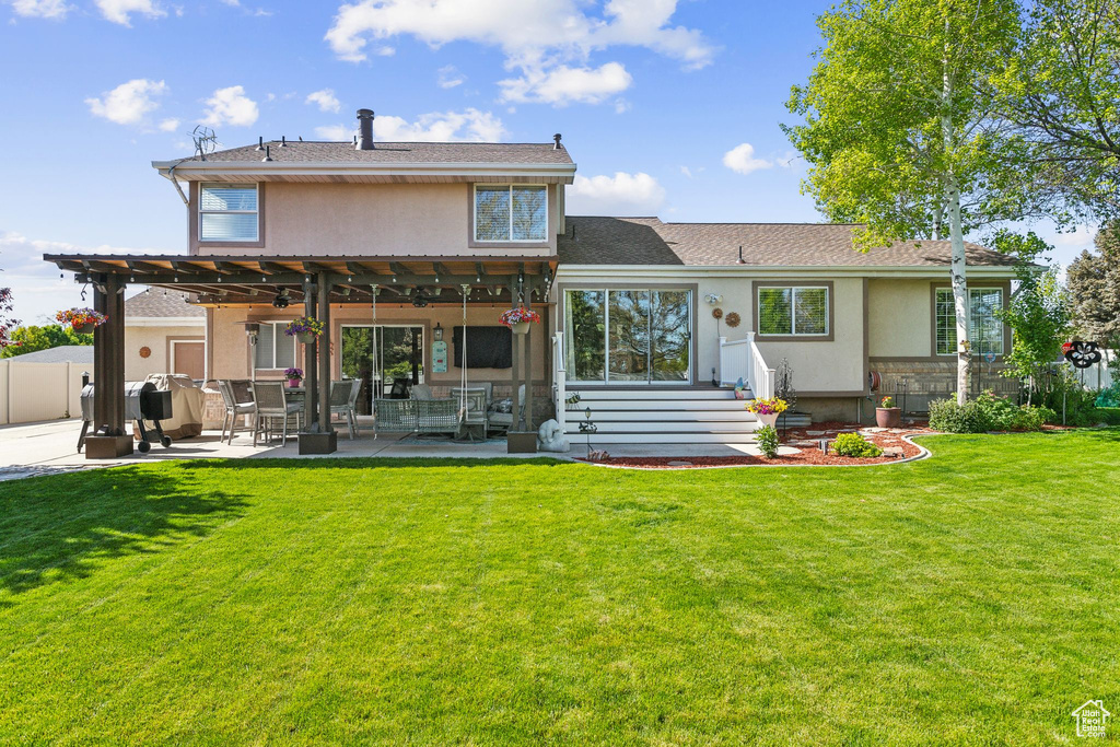 Back of house with a patio area, ceiling fan, and stucco siding