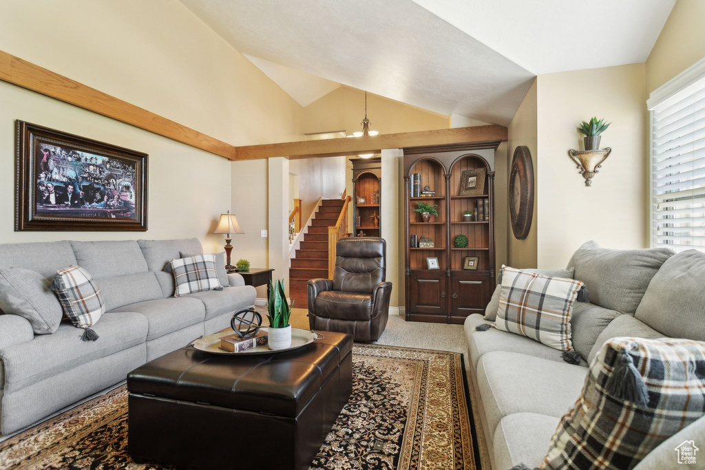 Carpeted living room featuring lofted ceiling and stairs