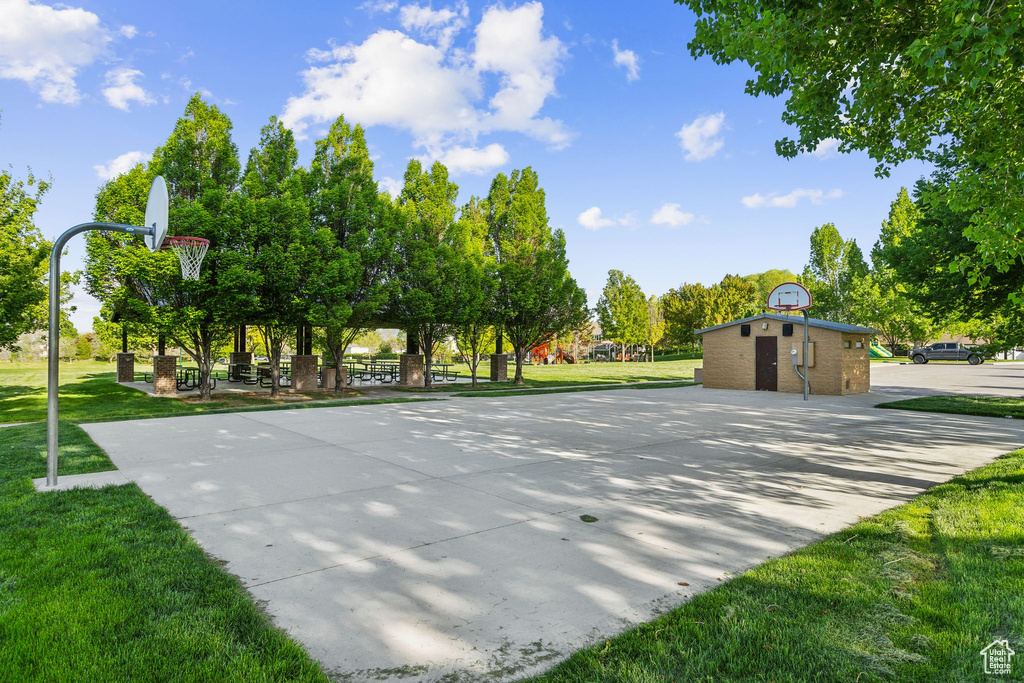 View of sport court featuring community basketball court and a lawn