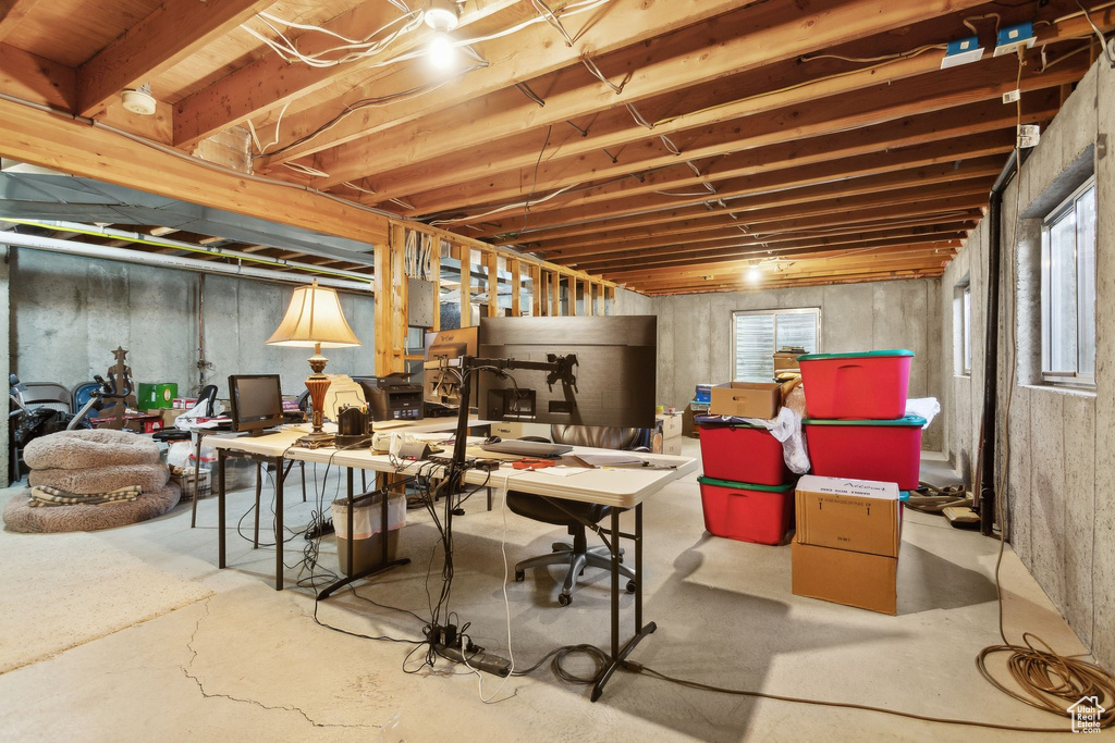 Below grade area with a desk and plenty of natural light