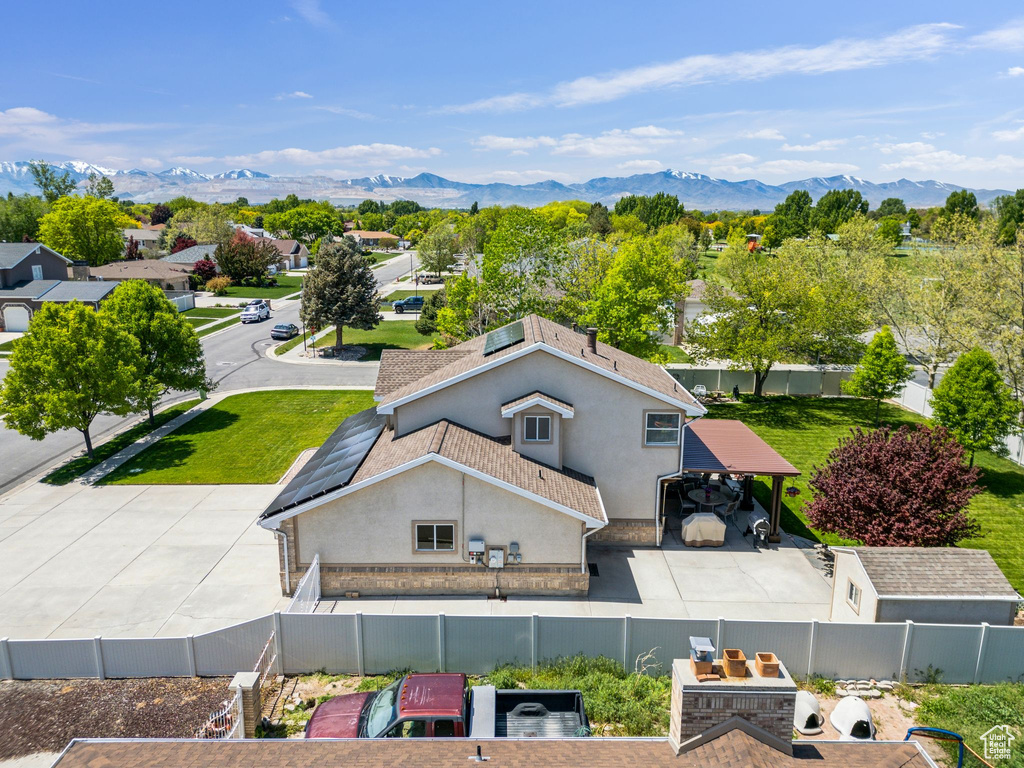 Aerial view of property and surrounding area featuring a mountainous background
