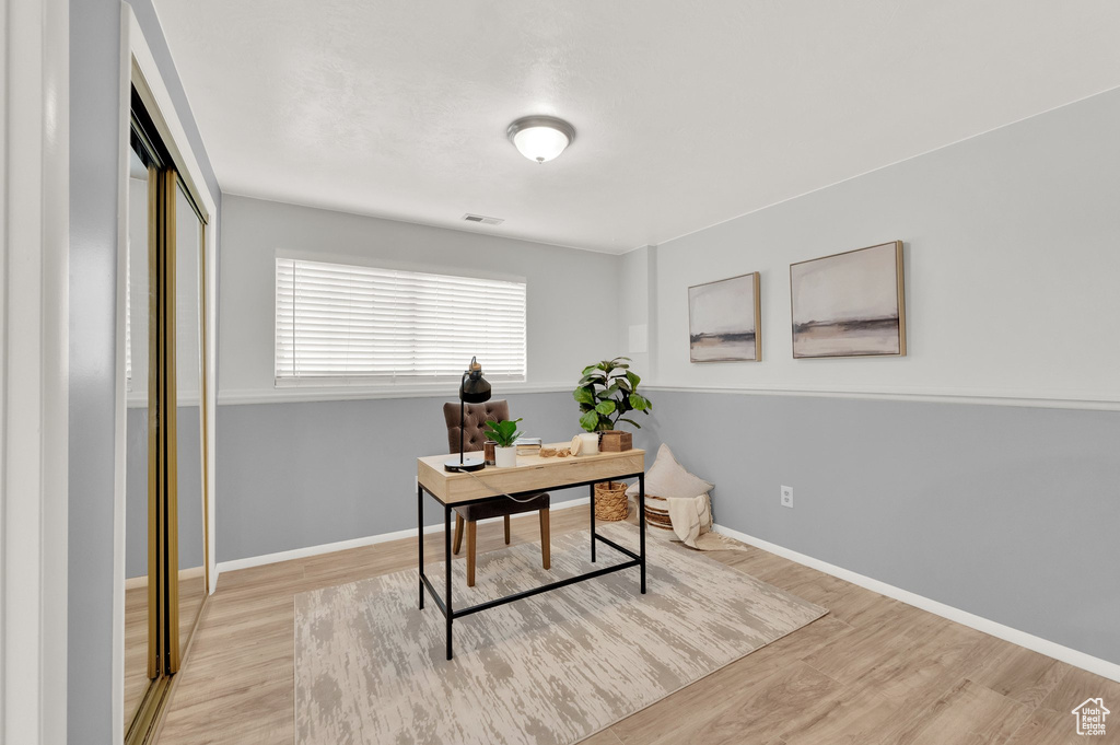 Home office featuring wood finished floors and baseboards