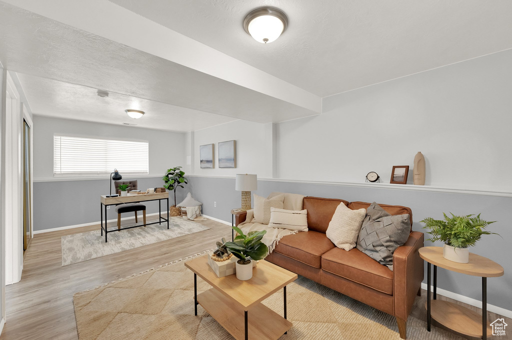 Living area with wood finished floors and baseboards