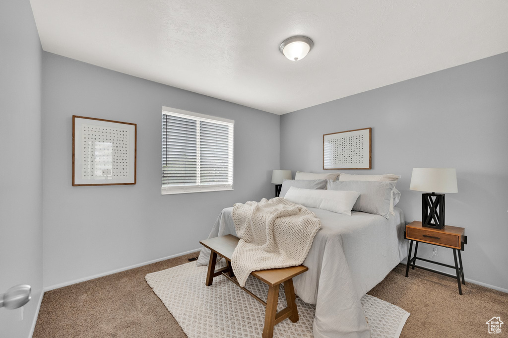 Carpeted bedroom with baseboards