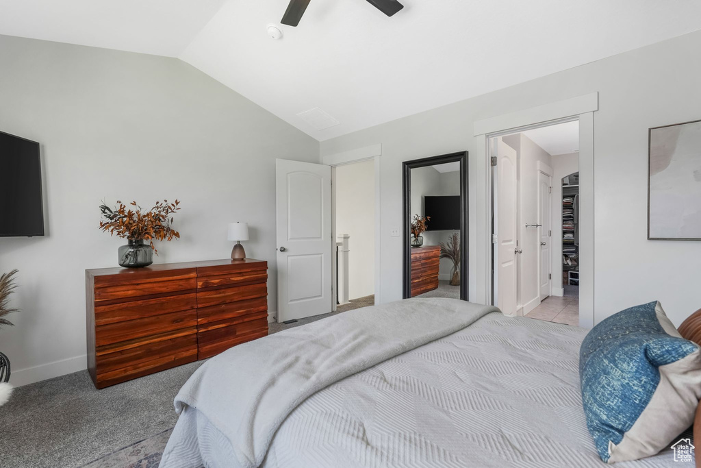 Bedroom featuring vaulted ceiling, baseboards, and ceiling fan