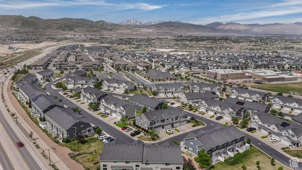 Aerial overview of property\'s location with a mountain backdrop and nearby suburban area