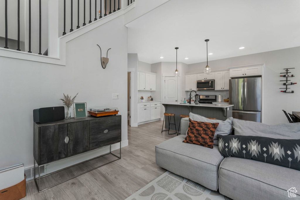 Living room featuring light wood-style flooring and recessed lighting
