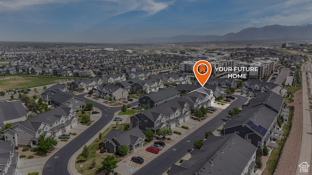 Aerial view of residential area featuring a mountainous background