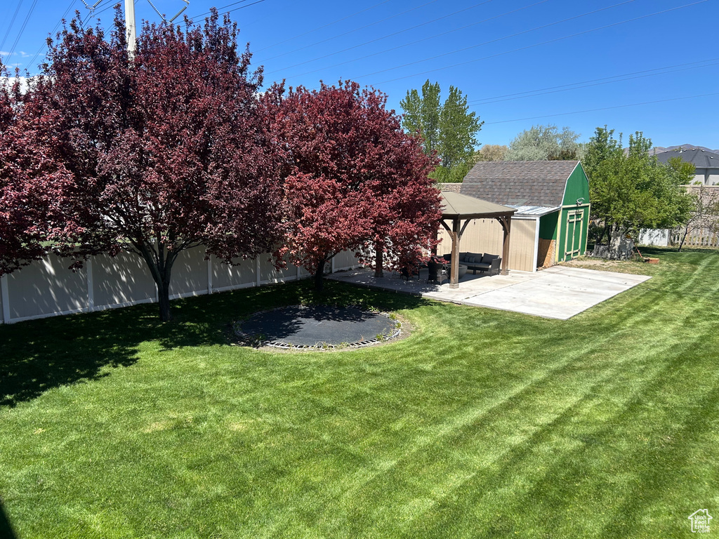 View of yard featuring a gazebo, a patio area, and an outbuilding