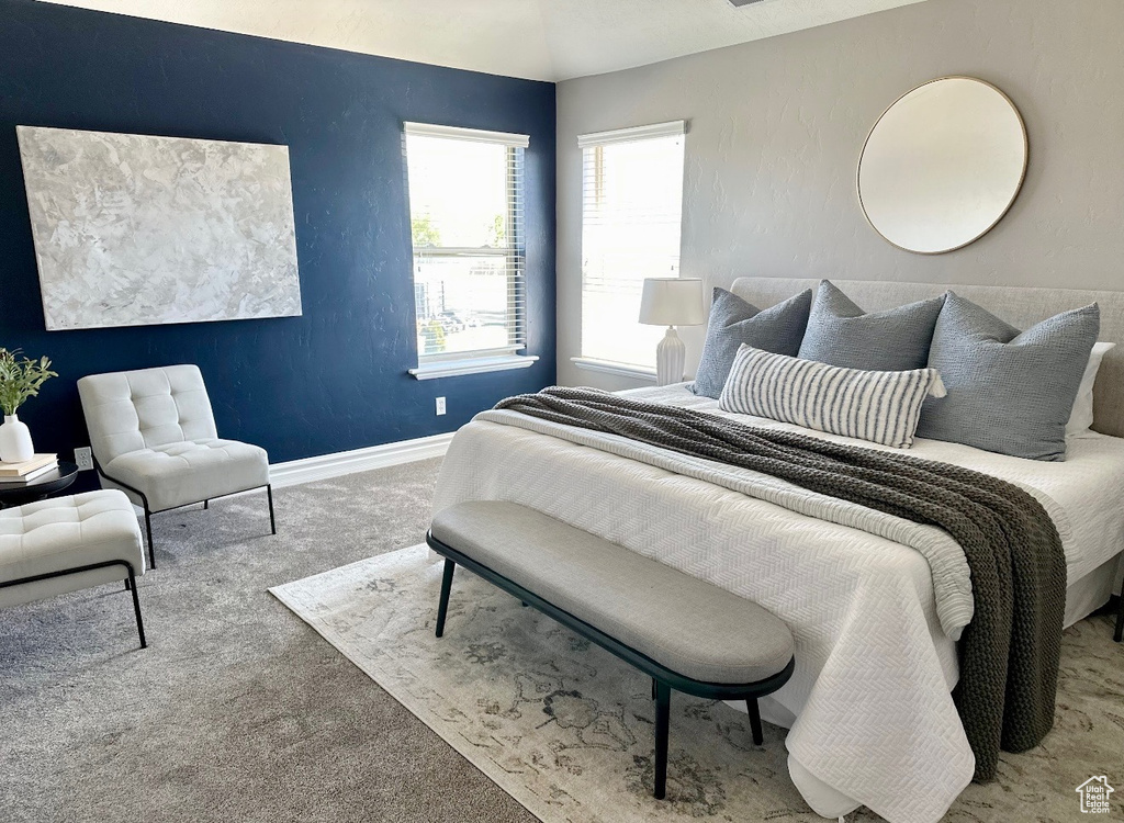 Bedroom featuring carpet flooring and baseboards