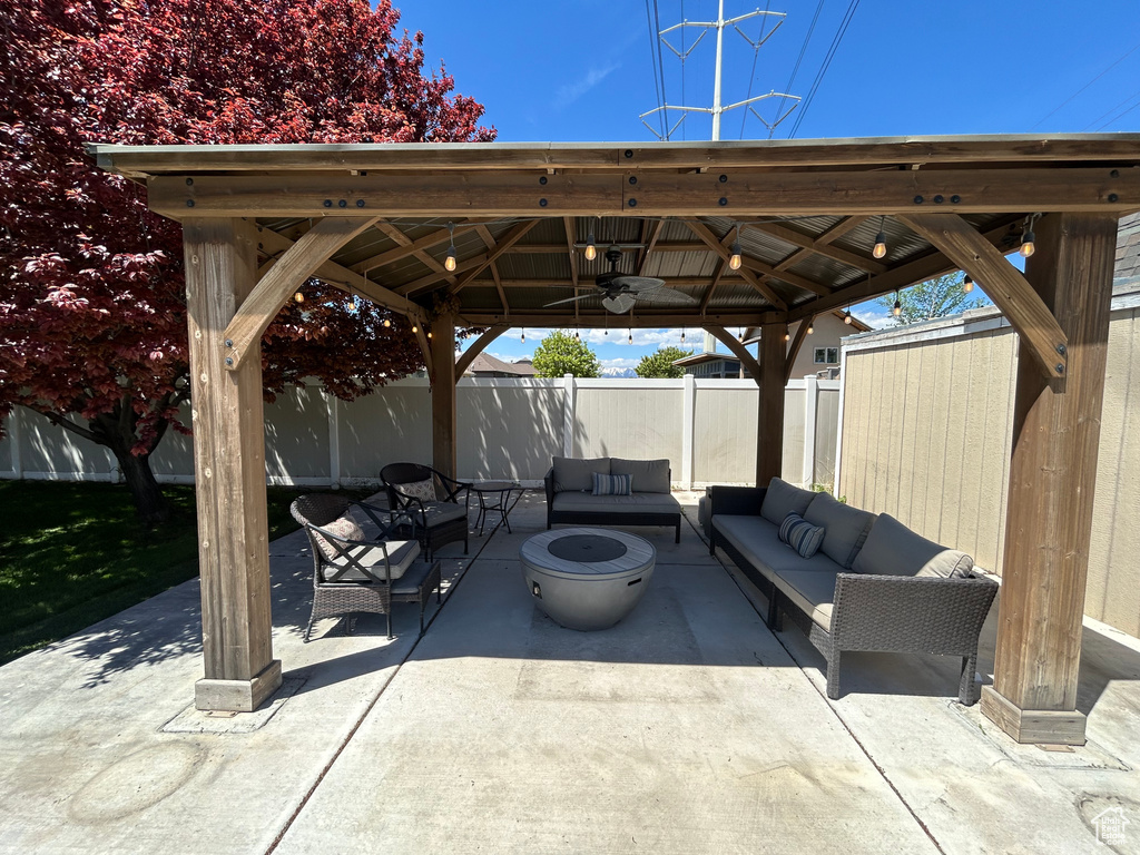 View of patio featuring a gazebo, outdoor lounge area, and a fenced backyard