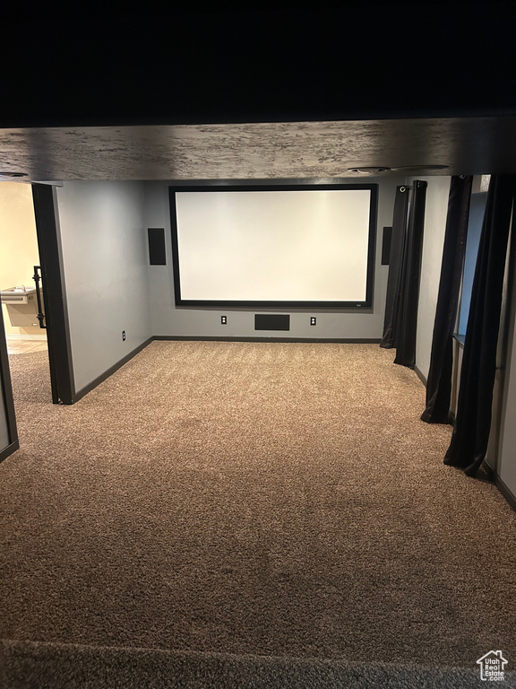 Home theater room featuring carpet floors and baseboards