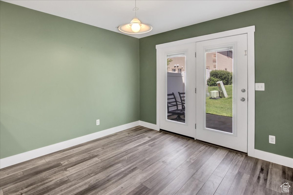 Unfurnished room with wood finished floors and baseboards