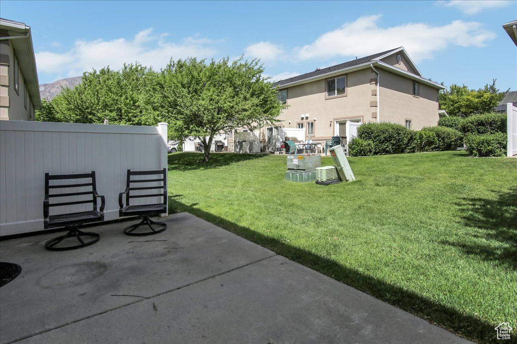 View of green lawn with a patio