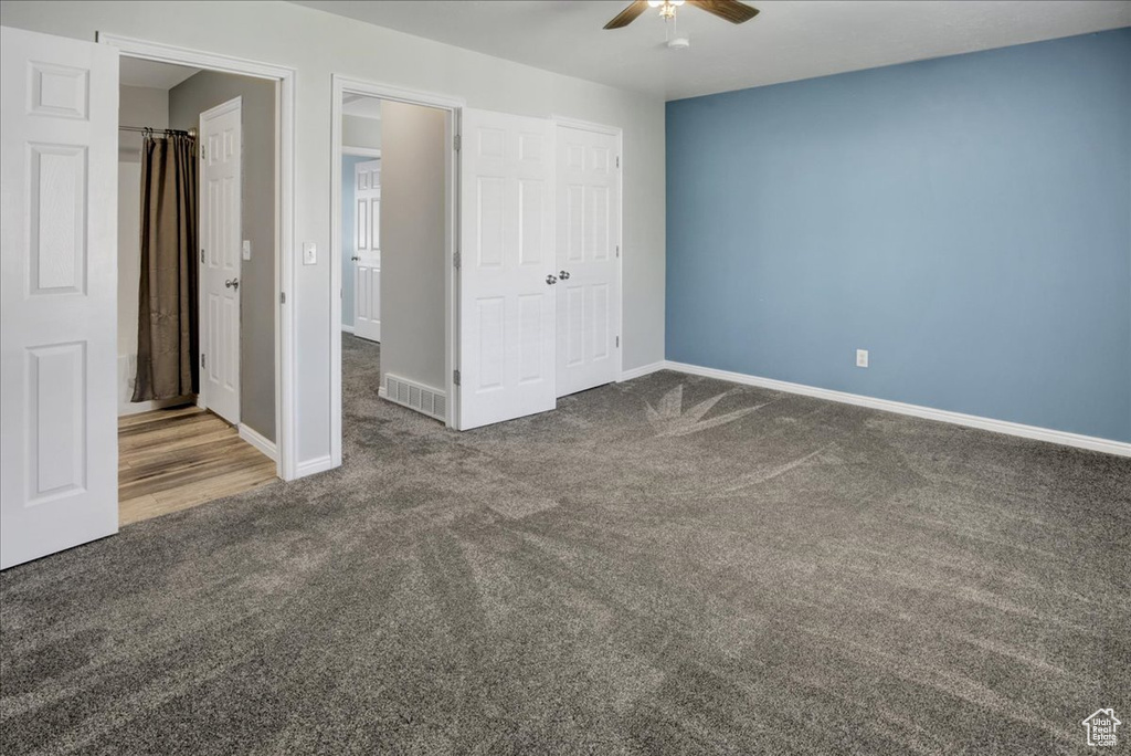Unfurnished bedroom featuring carpet, baseboards, a closet, and a ceiling fan