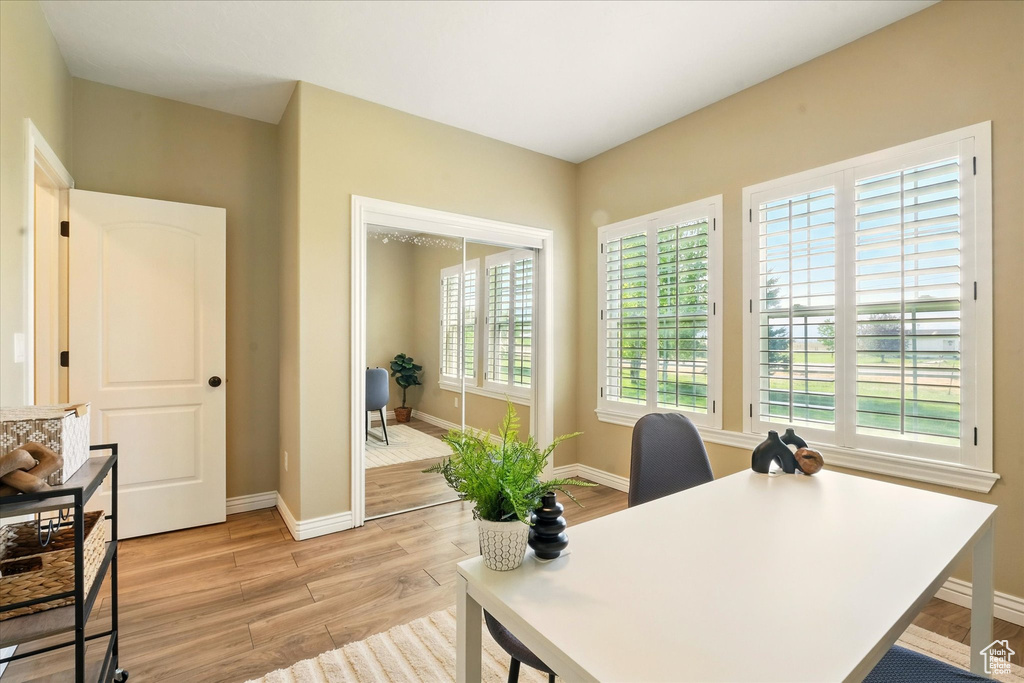Office area with light wood-style floors and baseboards