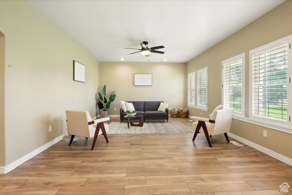 Sitting room with a ceiling fan, light wood-style floors, baseboards, and recessed lighting