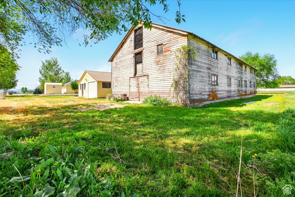 View of side of property with a yard