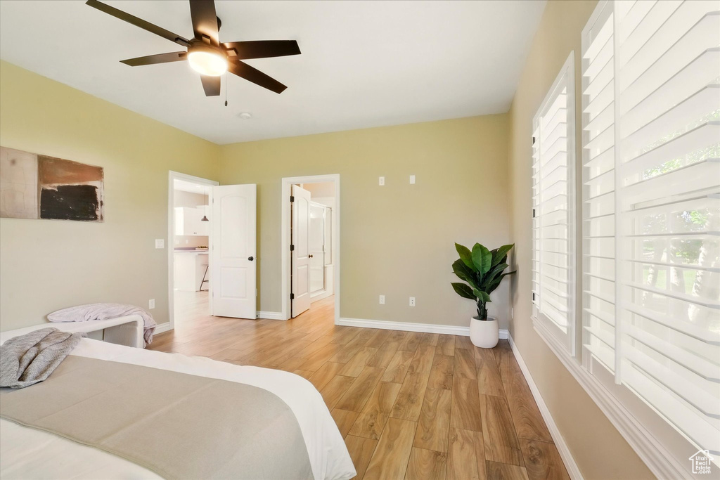 Bedroom with multiple windows and light wood-type flooring
