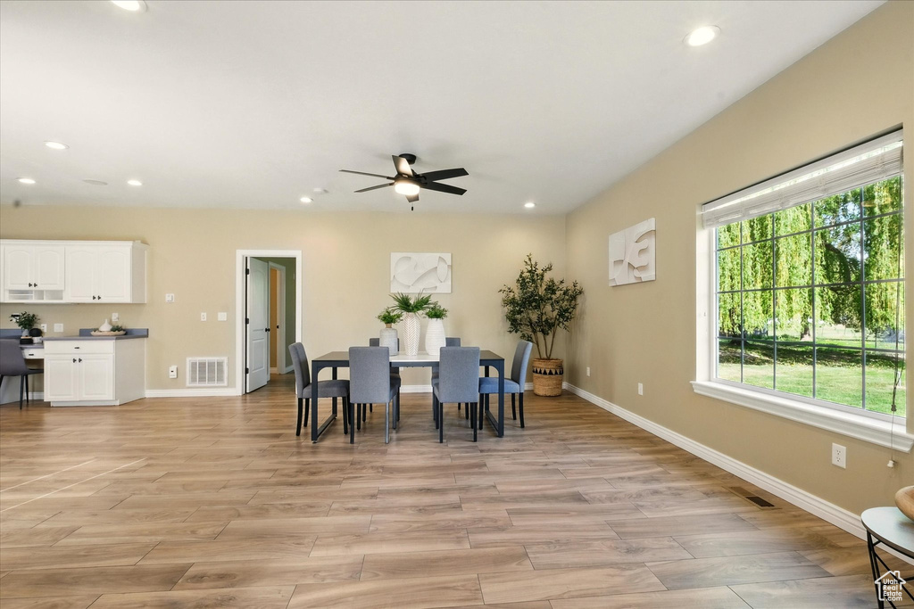 Dining area featuring ceiling fan, baseboards, recessed lighting, and light wood-style flooring