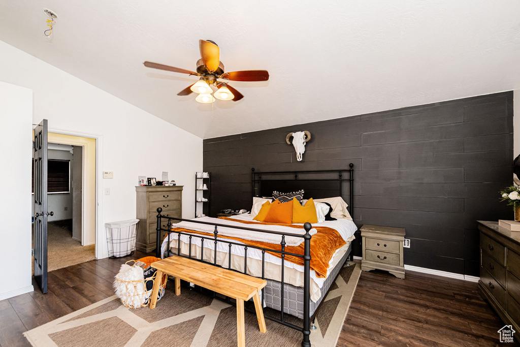 Bedroom featuring lofted ceiling, dark wood-type flooring, baseboards, and ceiling fan