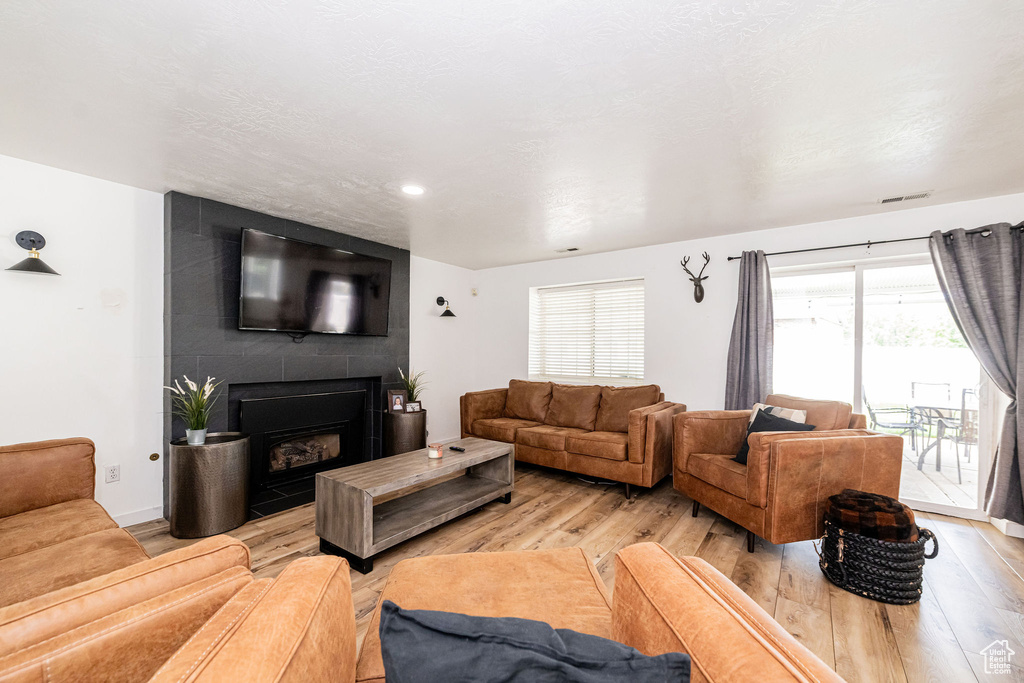 Living room featuring light wood finished floors and a fireplace