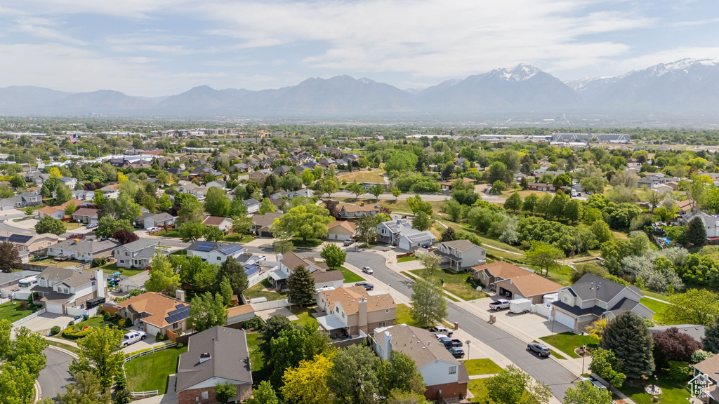 Aerial perspective of suburban area featuring a mountainous background