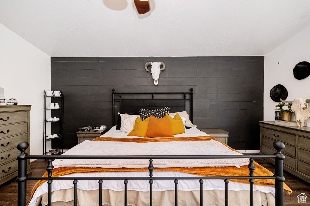 Bedroom with dark wood-style flooring