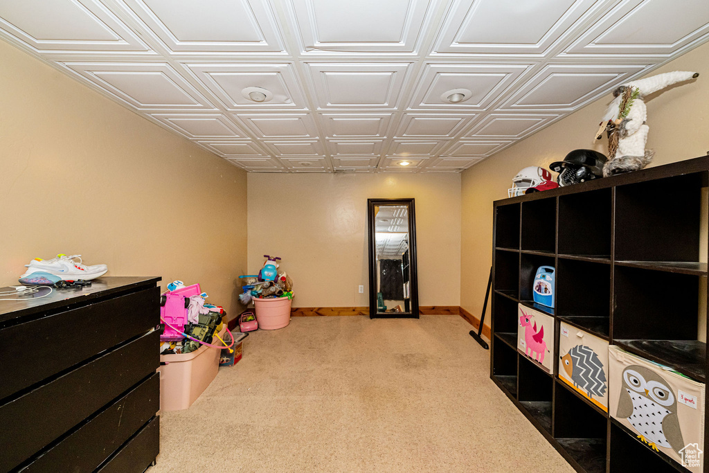 Game room featuring an ornate ceiling, carpet floors, and baseboards