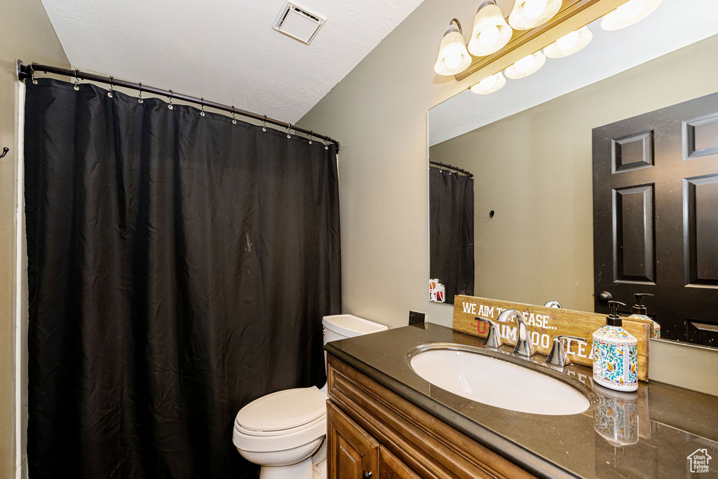 Full bath with toilet and vanity
