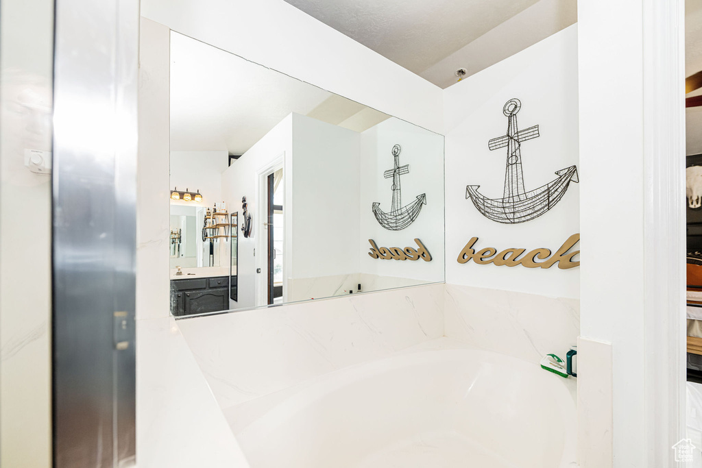 Full bath with a garden tub and vanity
