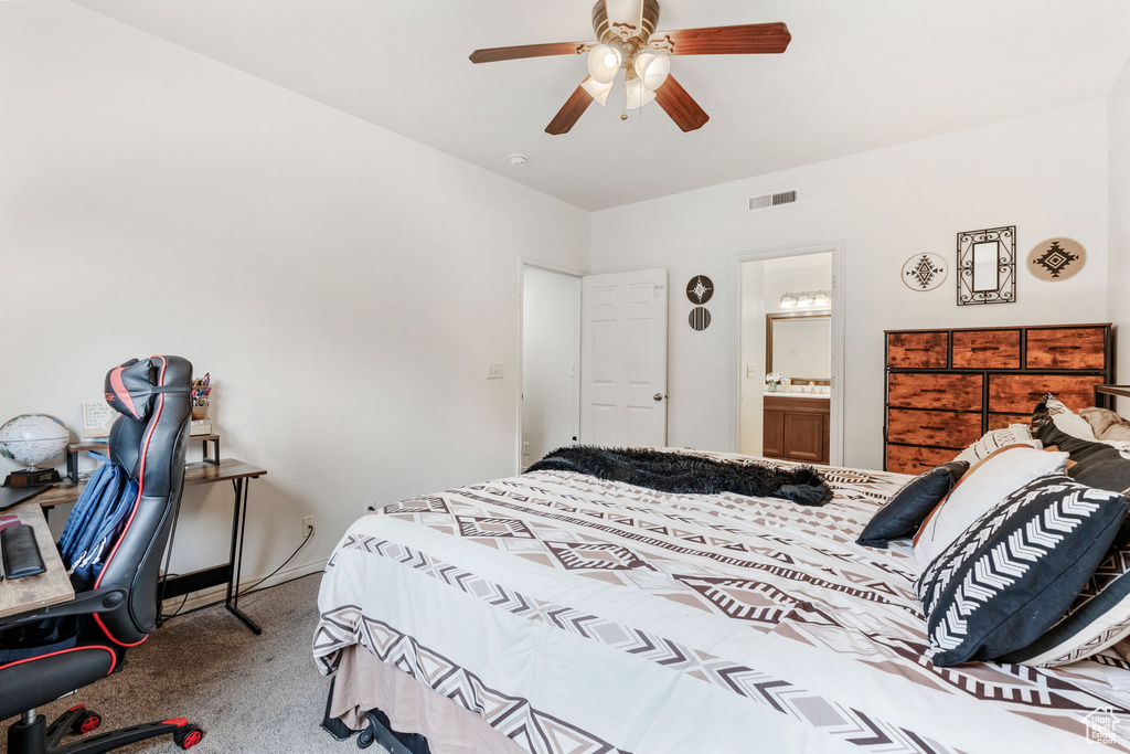 Carpeted bedroom featuring a ceiling fan and connected bathroom