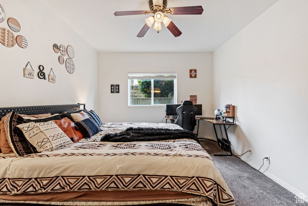 Bedroom featuring carpet, ceiling fan, and baseboards