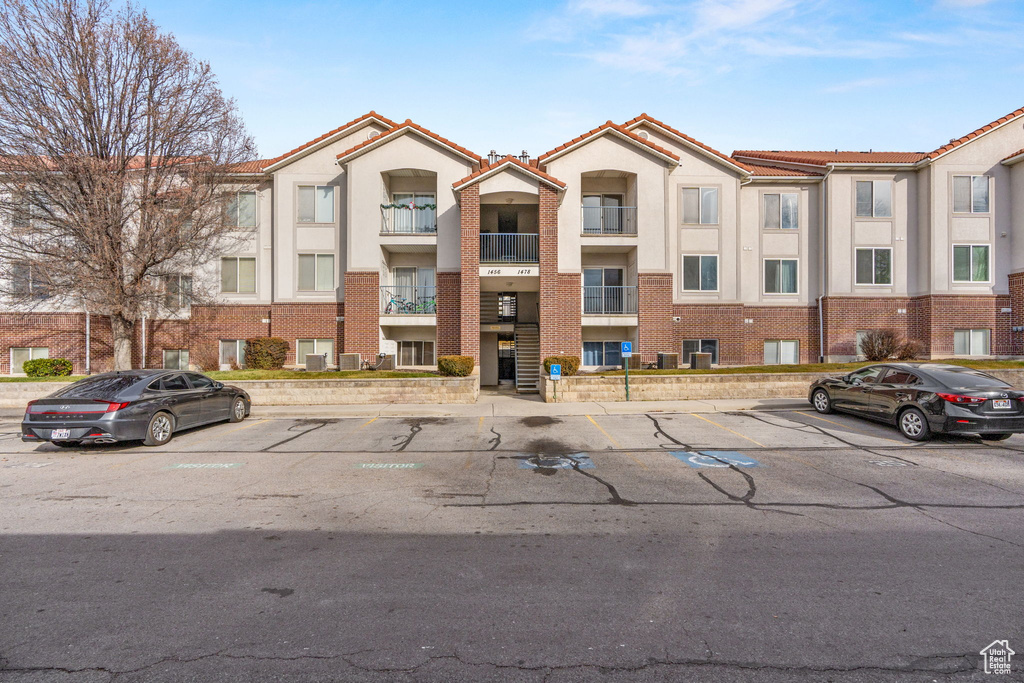 View of property with uncovered parking