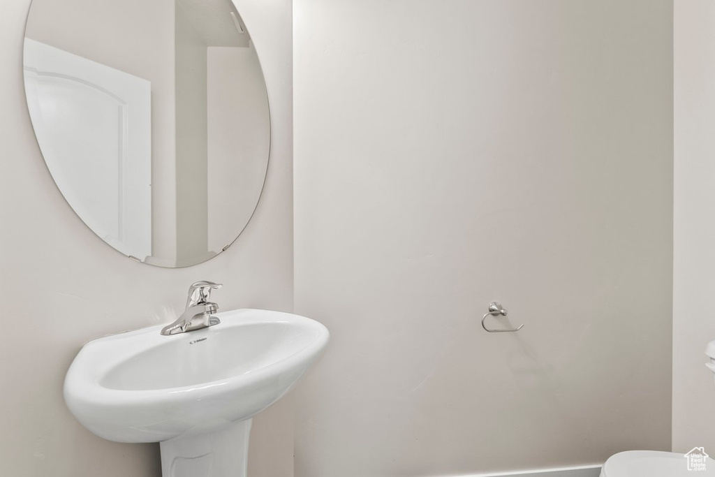 Half bathroom with a sink and toilet