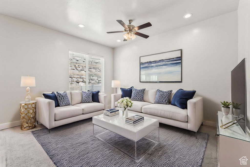 Living room featuring a ceiling fan, baseboards, and recessed lighting