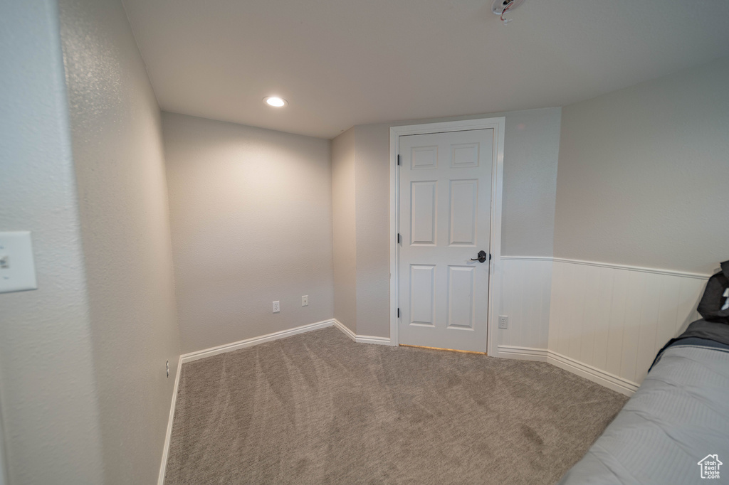 Unfurnished bedroom with carpet and baseboards