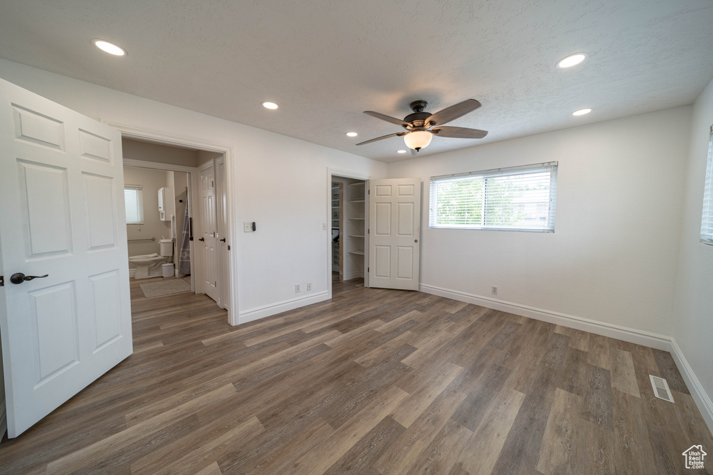 Unfurnished bedroom featuring baseboards, recessed lighting, wood finished floors, and a ceiling fan