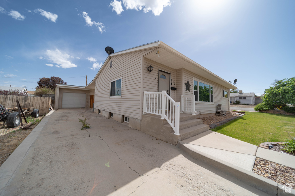 View of front of home with concrete driveway and a garage