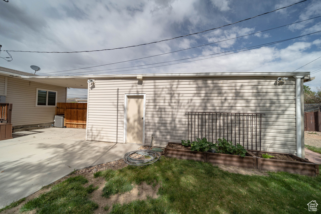 View of outbuilding featuring fence