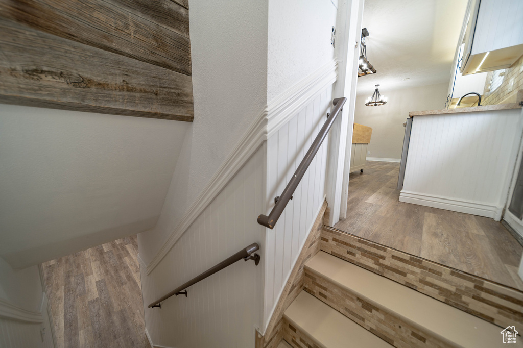 Stairway featuring wood finished floors