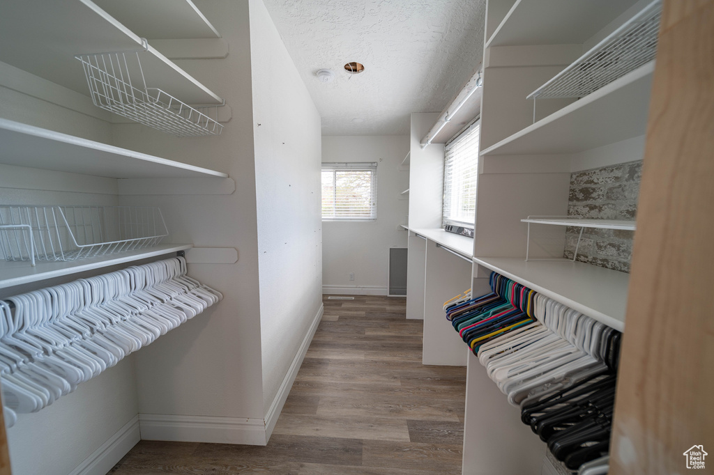 Walk in closet featuring wood finished floors