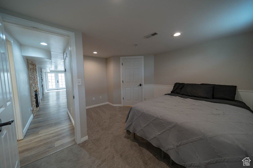 Bedroom with light colored carpet, baseboards, and recessed lighting