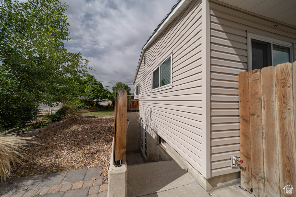 View of side of property featuring fence
