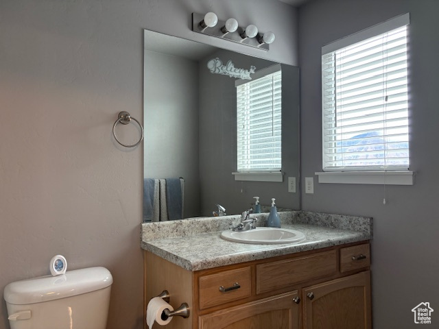 Half bathroom featuring toilet and vanity
