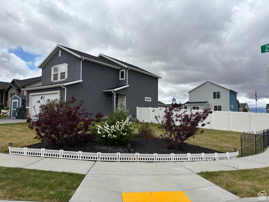 Traditional home featuring stucco siding and an attached garage
