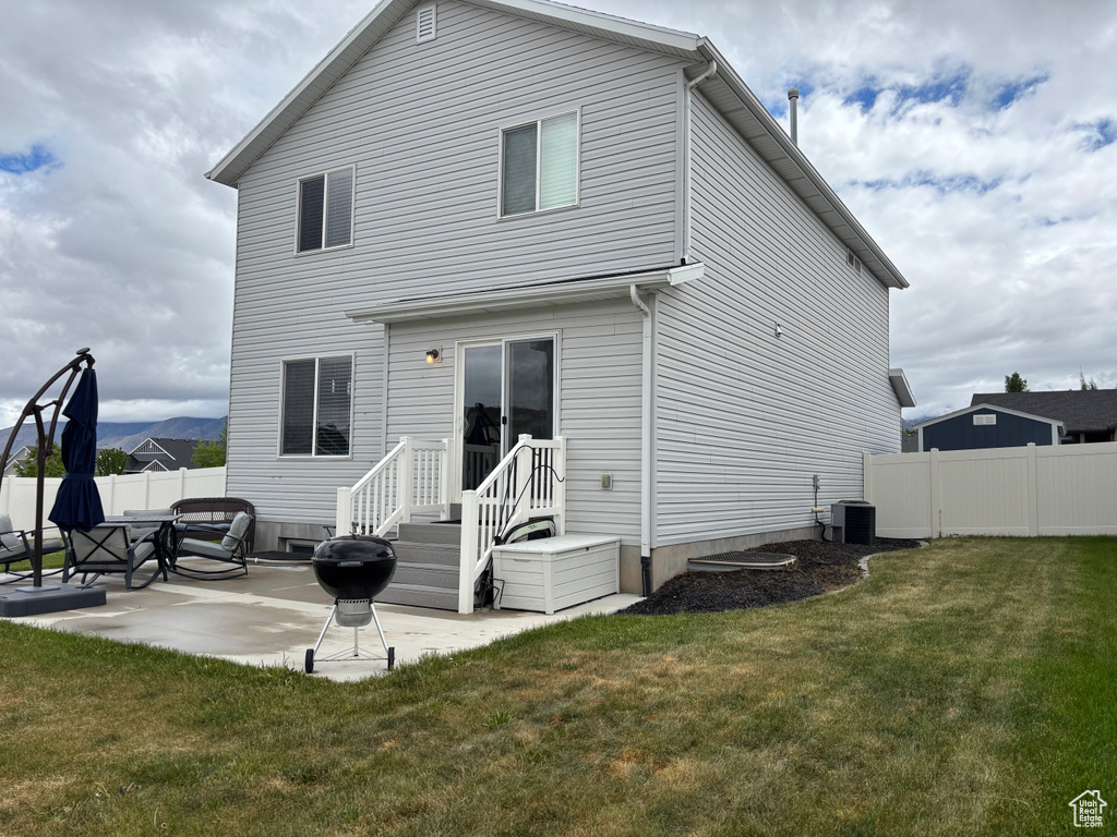 Back of house with a patio and central AC unit